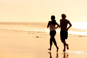 photo of people running on beach